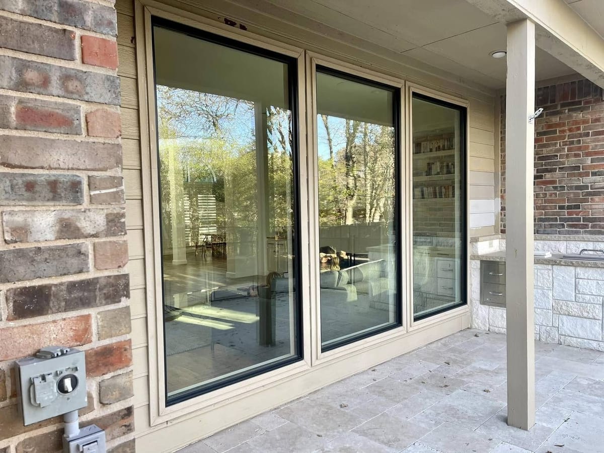 Wide square-top picture windows on a covered patio