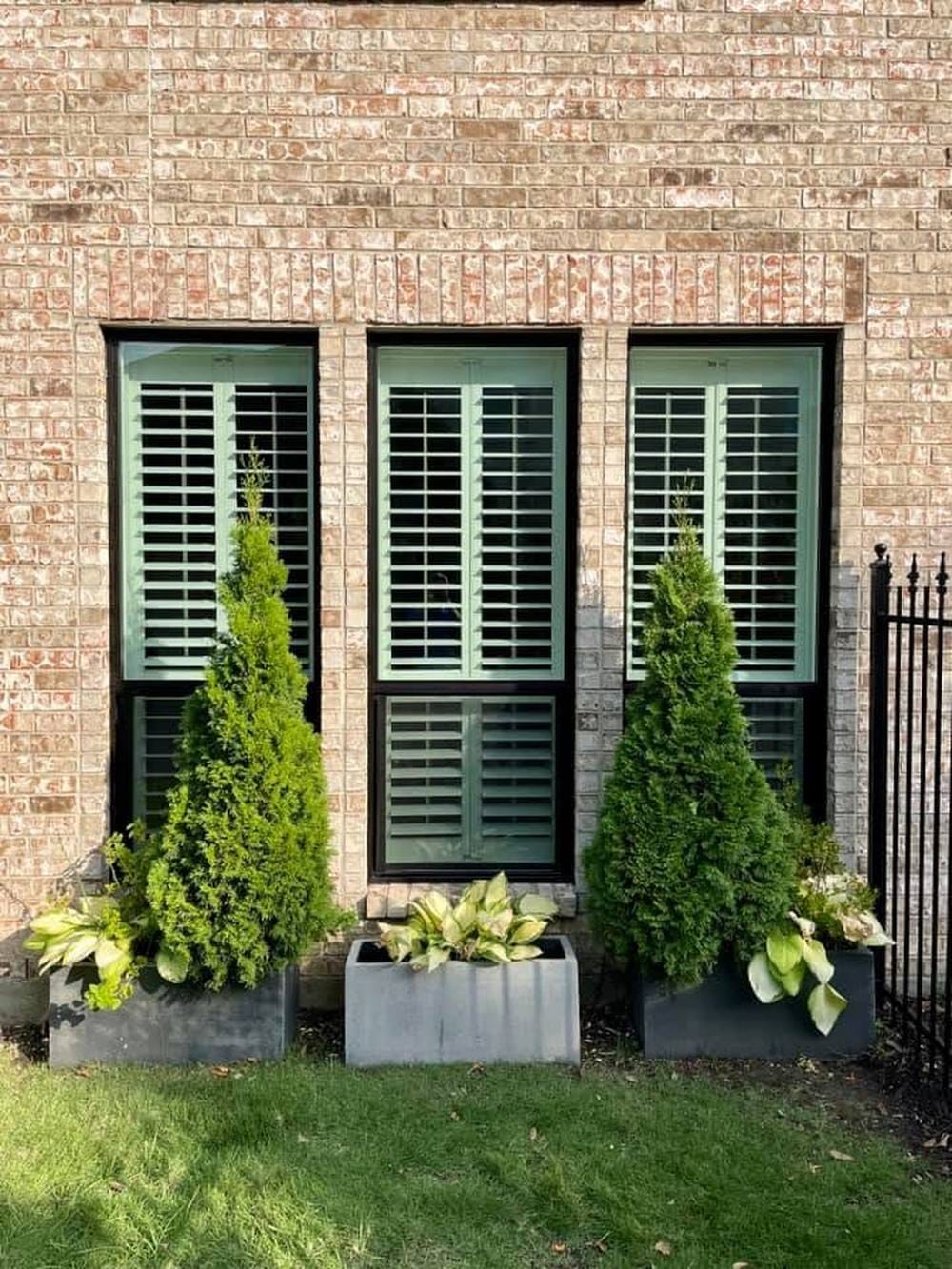 Three tall front-elevation windows with slim black frames and clear insulated glass.